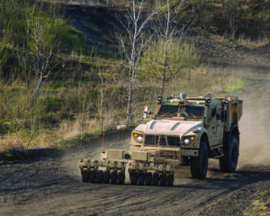 The unmanned TerraMax M-ATV with its mine roller.